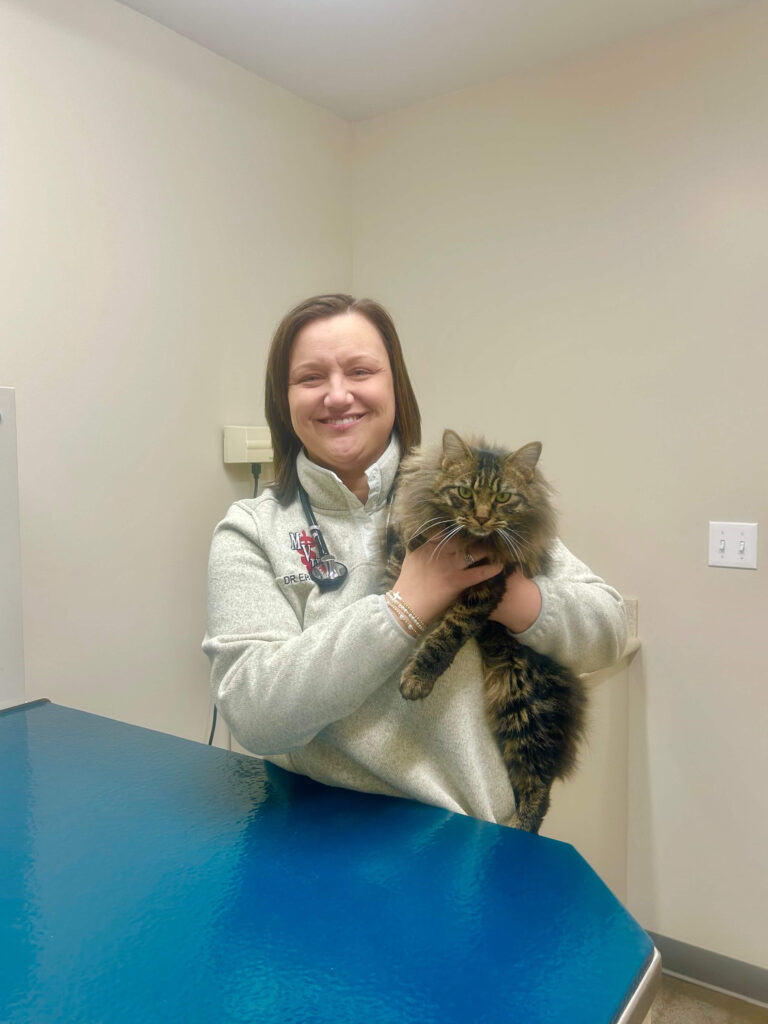 Dr. Erin Carnes holding a pet cat.
