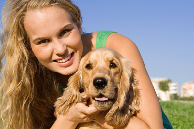 woman smiling with her pet dog